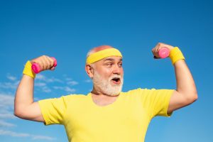 athletic old man and dumbells
